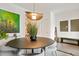 Contemporary dining room featuring an oval table, modern lighting, and minimalist decor at 1501 Millrock Trl, Wendell, NC 27591