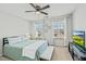 Well-lit bedroom with a ceiling fan, carpet, and a tv mounted on the wall at 1513 Reynolds Mill Rd, Wake Forest, NC 27587