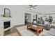 Open living room with hardwood floors, view of kitchen and fireplace at 1513 Reynolds Mill Rd, Wake Forest, NC 27587