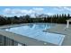 Large community swimming pool with lane markers, safety features, and surrounding trees at 1513 Reynolds Mill Rd, Wake Forest, NC 27587