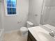 Bathroom featuring a toilet, vanity with a sink and a window providing natural light at 1599 Rogers Pointe Ln, Creedmoor, NC 27522
