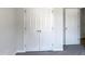 Bedroom closet with double doors, white trim and neutral carpet at 1599 Rogers Pointe Ln, Creedmoor, NC 27522