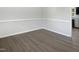 Open space with hardwood floors, view of the kitchen, and neutral walls ready for customization at 1599 Rogers Pointe Ln, Creedmoor, NC 27522