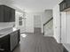 Modern kitchen with stainless steel appliances, dark cabinets, and hardwood floors at 1599 Rogers Pointe Ln, Creedmoor, NC 27522