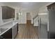 Open kitchen with stainless appliances, hardwood floors, and natural light at 1599 Rogers Pointe Ln, Creedmoor, NC 27522