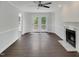Bright living room with fireplace, hardwood floors, ceiling fan and doors to a deck at 1599 Rogers Pointe Ln, Creedmoor, NC 27522