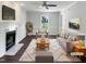 Bright, staged living room with a cozy fireplace, modern decor and plush rug at 1599 Rogers Pointe Ln, Creedmoor, NC 27522