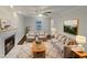 Bright living room featuring a fireplace, plush seating, and a stylish area rug at 1599 Rogers Pointe Ln, Creedmoor, NC 27522