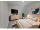 Comfortable main bedroom featuring a large bed, dresser and sleek TV at 1599 Rogers Pointe Ln, Creedmoor, NC 27522