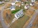 Wide aerial view showcasing a well-maintained home, storage shed, and a blue car on the street at 177 Clarence Ln, Garner, NC 27529