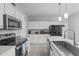 Bright kitchen featuring white cabinetry, stainless steel appliances, and a modern sink with stylish faucet at 177 Clarence Ln, Garner, NC 27529