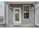 Charming back porch with a glass door, window, and outdoor light fixture at 1829 Knights Crest Way, Wake Forest, NC 27587