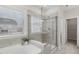 Modern bathroom featuring a glass enclosed shower and a luxurious soaking tub at 1829 Knights Crest Way, Wake Forest, NC 27587