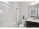 Bathroom featuring a shower-tub combo, vanity with dark cabinets, and neutral wall color at 1829 Knights Crest Way, Wake Forest, NC 27587