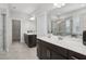 Modern bathroom with double vanity, tiled floor, a large mirror, and a glass shower at 1829 Knights Crest Way, Wake Forest, NC 27587