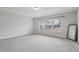 Spacious bedroom with tray ceiling, a large window offering natural light, and neutral carpet at 1829 Knights Crest Way, Wake Forest, NC 27587