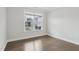 Bright bedroom with hardwood floors, a large window, and neutral paint, creating a serene atmosphere at 1829 Knights Crest Way, Wake Forest, NC 27587