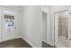 Bright entryway with hardwood floors, access to a shower room, and a door with a window at 1829 Knights Crest Way, Wake Forest, NC 27587