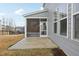 Spacious backyard with a screened-in porch extending from the house and a concrete patio at 1829 Knights Crest Way, Wake Forest, NC 27587