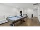 Bright game room featuring a pool table, light hardwood flooring, and a cozy white couch at 1829 Knights Crest Way, Wake Forest, NC 27587