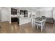 Open-concept view of the kitchen and dining area with hardwood floors at 1829 Knights Crest Way, Wake Forest, NC 27587