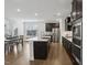 Open kitchen view features a center island, stainless appliances, and an adjacent dining area at 1829 Knights Crest Way, Wake Forest, NC 27587