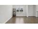 Bright living room features hardwood floors, a large window, and a small shelf adding character to the space at 1829 Knights Crest Way, Wake Forest, NC 27587