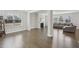 Open-concept living room with hardwood floors, a fireplace, large windows, and neutral tones for versatile decor at 1829 Knights Crest Way, Wake Forest, NC 27587