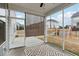 Relaxing screened porch with an outdoor rug and view of the backyard play area at 1829 Knights Crest Way, Wake Forest, NC 27587