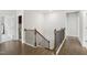 Upstairs landing features a staircase with wood and iron railing at 1829 Knights Crest Way, Wake Forest, NC 27587