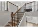 Staircase features hardwood steps and black iron spindles at 1829 Knights Crest Way, Wake Forest, NC 27587