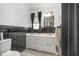 Modern bathroom showcases black and white tiles, updated fixtures, and ample natural light at 2005 Sutphin Dr, Sanford, NC 27330