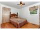 Inviting bedroom features natural lighting, a ceiling fan, and hardwood floors at 2005 Sutphin Dr, Sanford, NC 27330