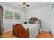 Cozy bedroom features a wooden bed frame, hardwood floors, and natural light at 2005 Sutphin Dr, Sanford, NC 27330