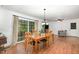 Charming dining room featuring hardwood floors, a wooden dining table, and views of the backyard at 2005 Sutphin Dr, Sanford, NC 27330