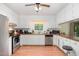 Functional kitchen with stainless steel appliances, white cabinetry, and a bright window over the sink at 2005 Sutphin Dr, Sanford, NC 27330