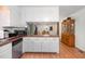 Open kitchen design with white cabinetry, stainless appliances, and a view of the dining area at 2005 Sutphin Dr, Sanford, NC 27330