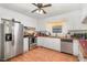 Well-lit kitchen features stainless steel appliances, updated cabinetry, and a ceiling fan at 2005 Sutphin Dr, Sanford, NC 27330