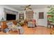 A cozy living room area features wood flooring, a ceiling fan, and an entertainment center at 2005 Sutphin Dr, Sanford, NC 27330