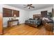 Warm main bedroom features a wood-toned ceiling fan, hardwood floors, and comfortable furnishings at 2005 Sutphin Dr, Sanford, NC 27330