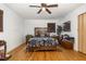 Comfortable main bedroom features stylish furnishings, a ceiling fan, and hardwood floors at 2005 Sutphin Dr, Sanford, NC 27330