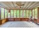 Enclosed sunroom featuring many windows and view of the wooded backyard at 2005 Sutphin Dr, Sanford, NC 27330