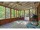 Enclosed sunroom with plenty of natural light, fan, and outdoor views at 2005 Sutphin Dr, Sanford, NC 27330