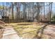 Spacious backyard featuring a well-manicured lawn and a storage shed, offering practical outdoor space at 209 Hutchins Dr, Garner, NC 27529