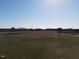 Aerial view of a serene landscape showcasing a large field stretching towards a distant home at 2113 Nc 55, Coats, NC 27521