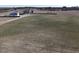 Aerial view of land with a home in the background, offering a serene setting and ample space for building at 2113 Nc 55, Coats, NC 27521