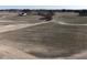 Aerial view of land with a home in the background, offering a serene setting and ample space for building at 2113 Nc 55, Coats, NC 27521
