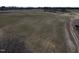 Aerial view of land with a home in the background, offering a serene setting and ample space for building at 2113 Nc 55, Coats, NC 27521