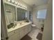 This bathroom features a vanity with ample storage, tile flooring, and neutral colors at 2113 Nc 55, Coats, NC 27521