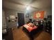 Cozy bedroom featuring hardwood floors, a ceiling fan, and decor of your favorite sports team at 2113 Nc 55, Coats, NC 27521